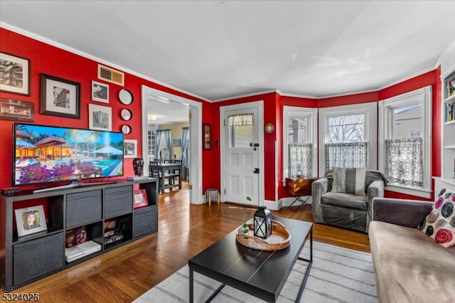 living room with hardwood / wood-style floors and ornamental molding