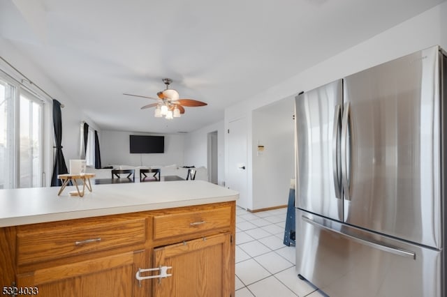 kitchen featuring ceiling fan, stainless steel fridge, and light tile patterned floors