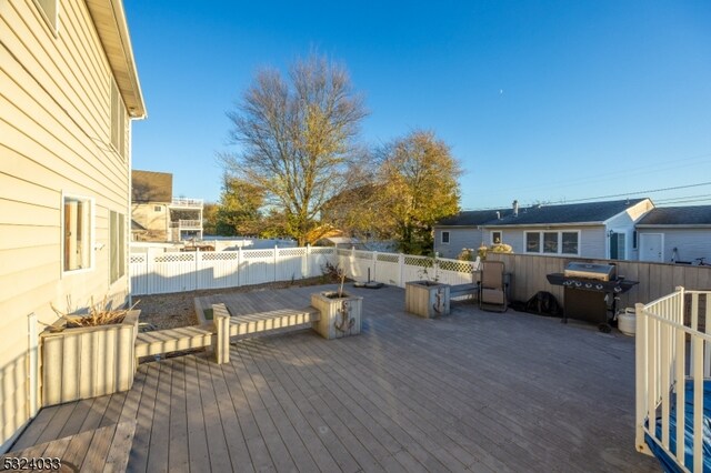 wooden terrace with area for grilling