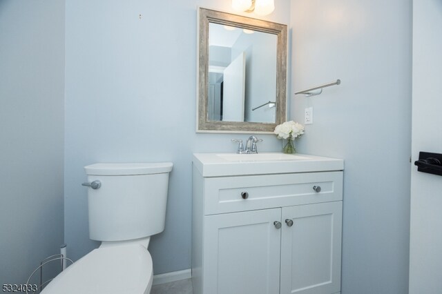 bathroom featuring toilet and vanity