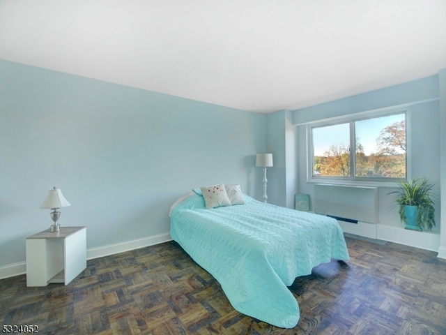 bedroom with dark parquet flooring