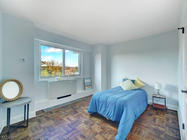 bedroom with dark parquet flooring