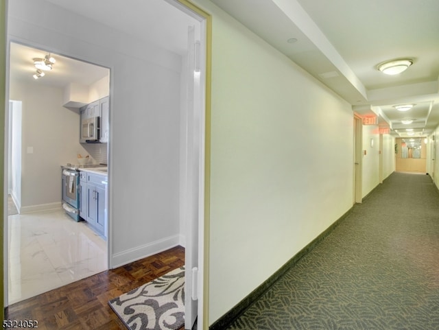 corridor featuring dark parquet flooring