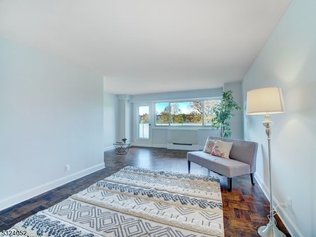 sitting room featuring dark hardwood / wood-style flooring and a baseboard heating unit