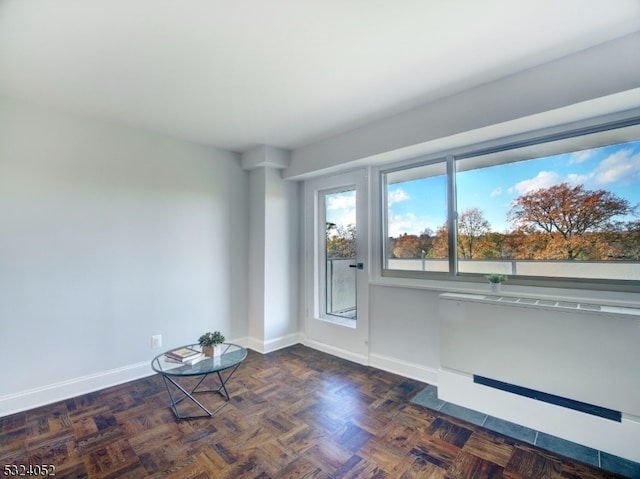 spare room with dark parquet floors