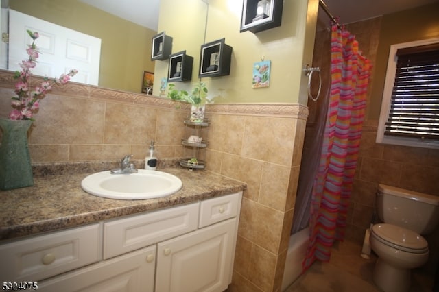 bathroom with tile walls, walk in shower, vanity, and toilet