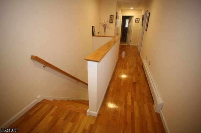 hall featuring baseboard heating and light wood-type flooring