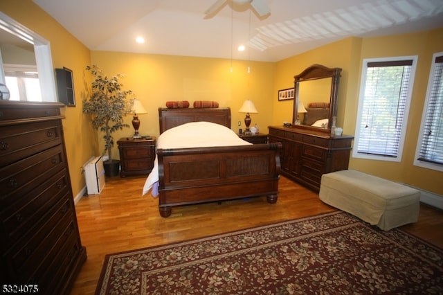 bedroom featuring lofted ceiling, wood-type flooring, and ceiling fan