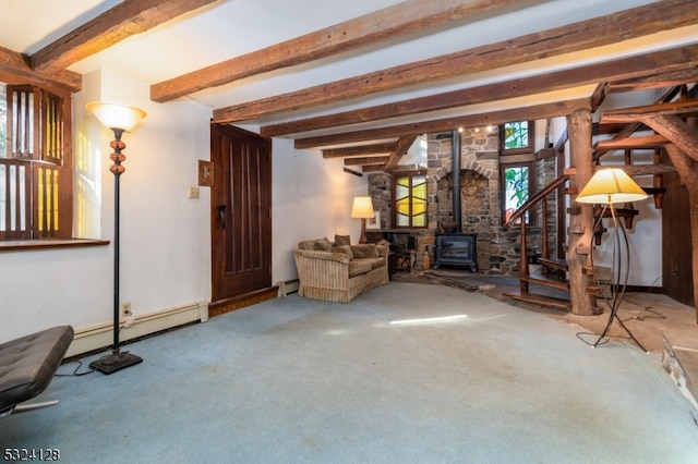 unfurnished living room with baseboard heating, beam ceiling, a wood stove, and carpet floors