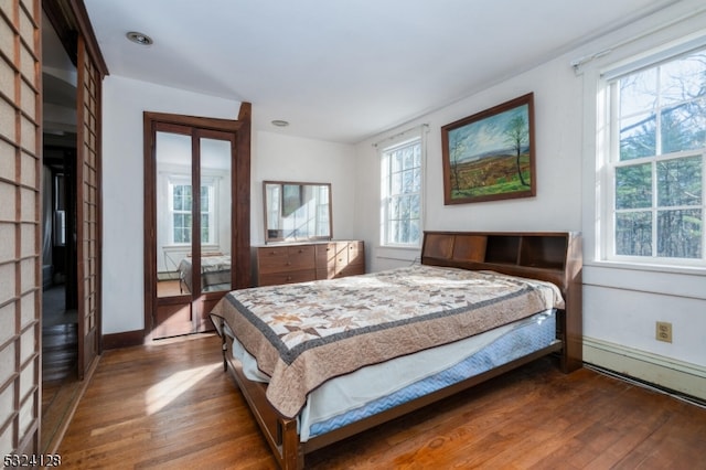 bedroom with dark hardwood / wood-style floors