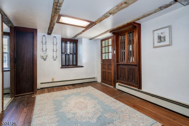 entrance foyer with baseboard heating, dark hardwood / wood-style floors, and beam ceiling