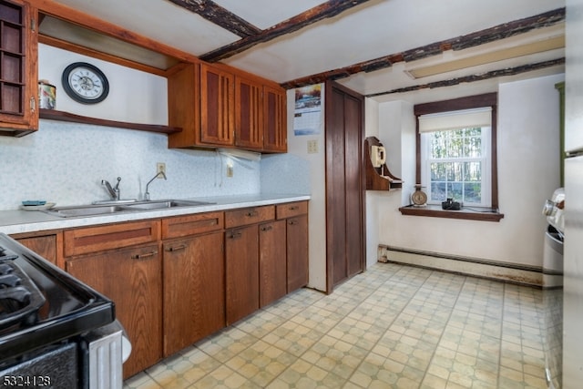 kitchen featuring black electric range oven, a baseboard radiator, sink, and decorative backsplash