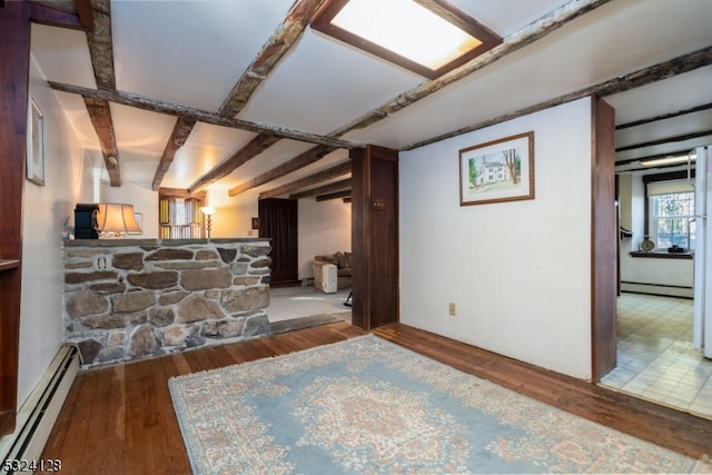 interior space featuring baseboard heating and hardwood / wood-style flooring