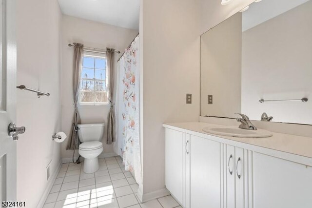 full bath with tile patterned flooring, toilet, vanity, and baseboards