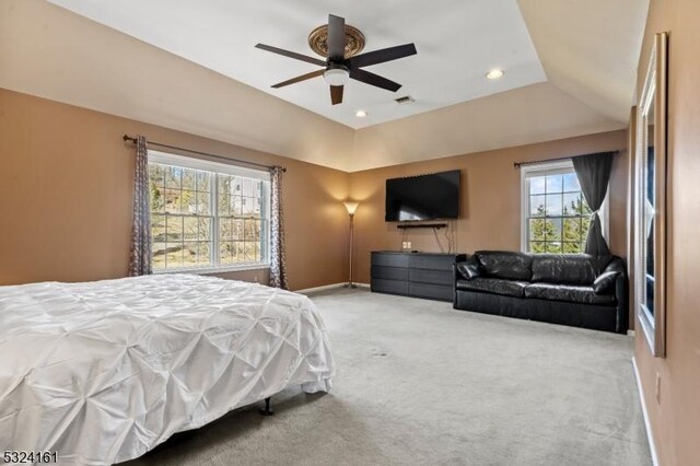 carpeted bedroom with a ceiling fan, a tray ceiling, recessed lighting, and baseboards