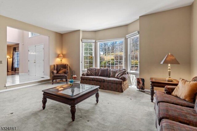 living room featuring carpet flooring and baseboards