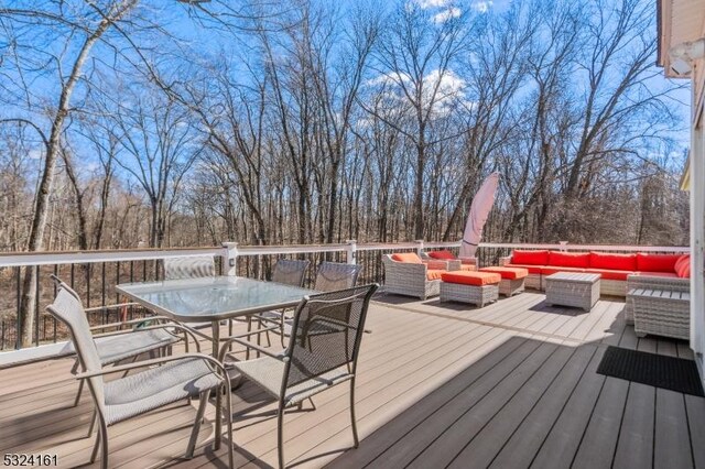 deck featuring outdoor dining space and outdoor lounge area