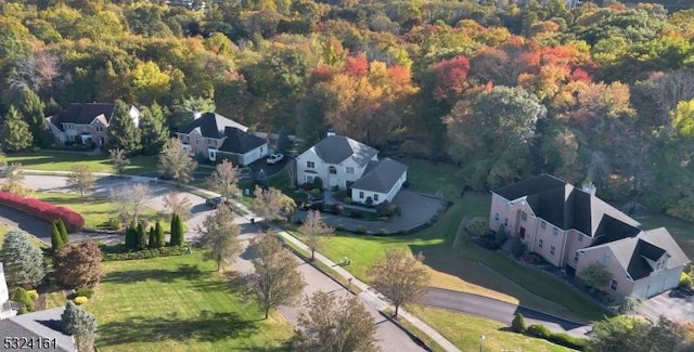 bird's eye view featuring a view of trees and a residential view