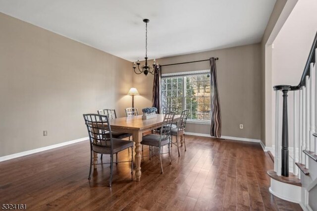 dining room featuring stairway, baseboards, an inviting chandelier, and dark wood finished floors