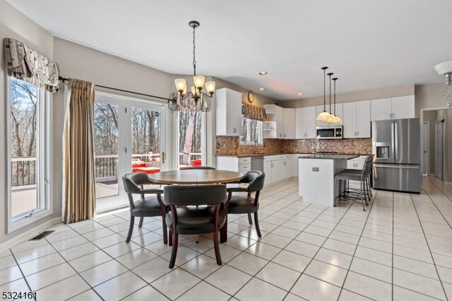 dining area featuring light tile patterned floors, recessed lighting, visible vents, and a chandelier