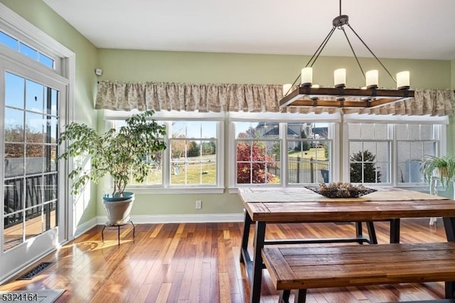 unfurnished sunroom with a chandelier