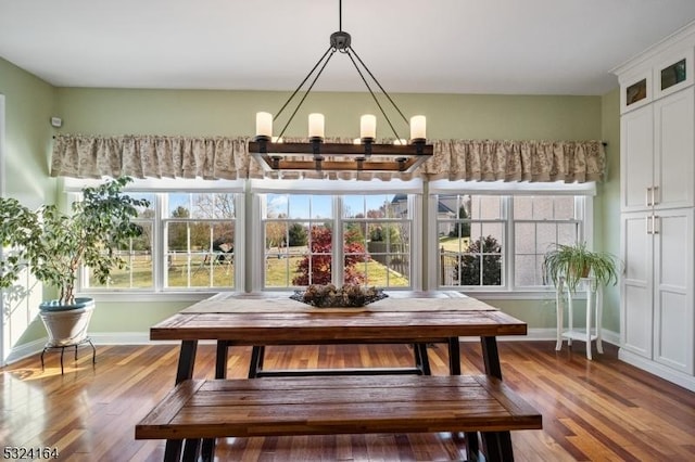 unfurnished dining area with hardwood / wood-style flooring and an inviting chandelier