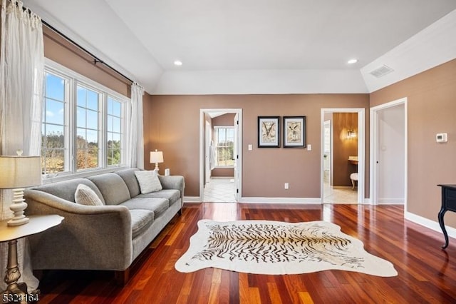 living room with dark hardwood / wood-style floors and vaulted ceiling