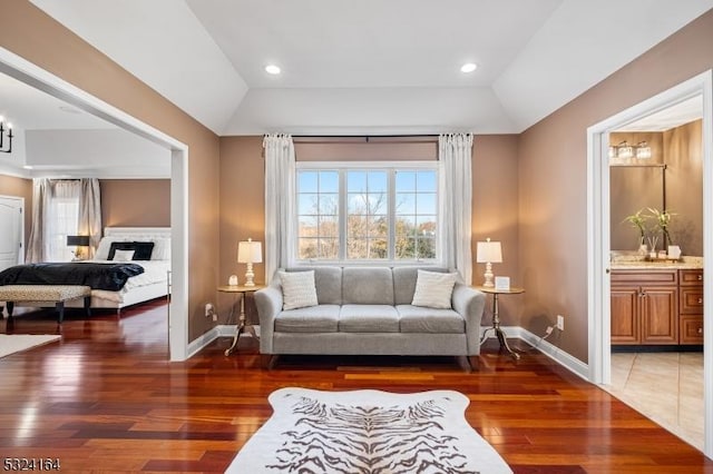 living room featuring dark hardwood / wood-style flooring and vaulted ceiling