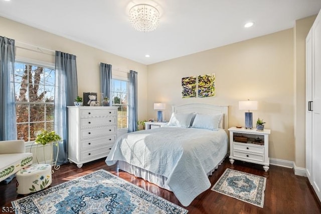 bedroom with an inviting chandelier and dark wood-type flooring