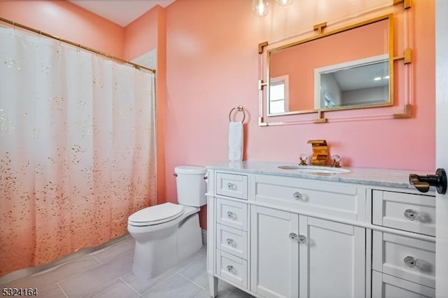 bathroom with tile patterned flooring, vanity, and toilet