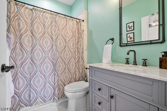 bathroom featuring vanity and toilet