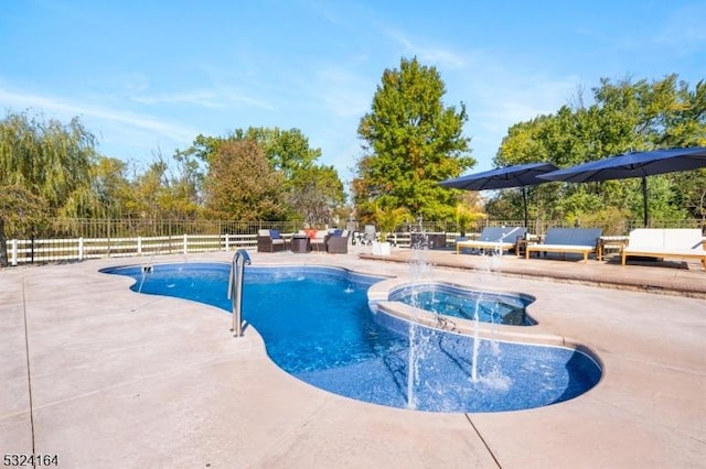 view of swimming pool featuring a patio area and an in ground hot tub