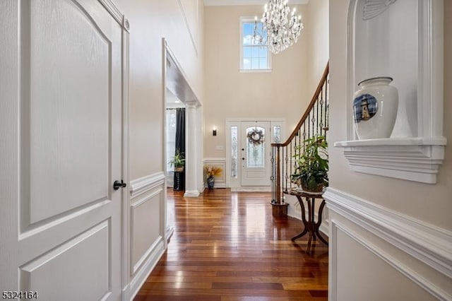 entrance foyer featuring an inviting chandelier and dark hardwood / wood-style flooring