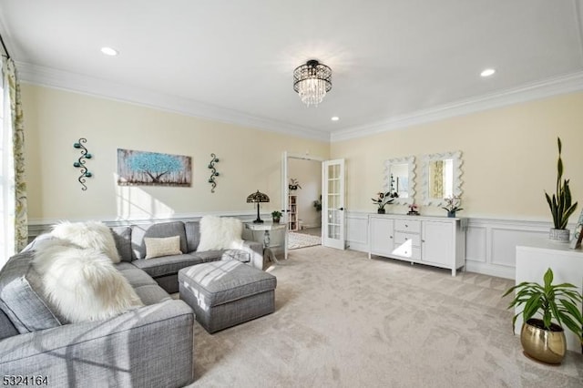 carpeted living room with crown molding, a chandelier, and french doors