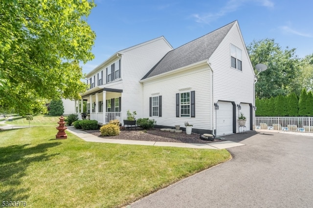 exterior space with a garage and a lawn