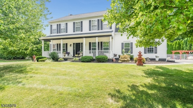 colonial inspired home with covered porch and a front lawn