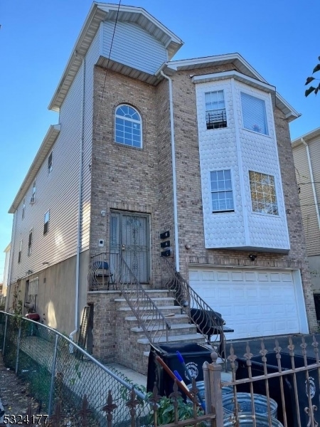 rear view of property with a garage