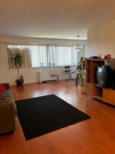 living room featuring hardwood / wood-style floors and a chandelier