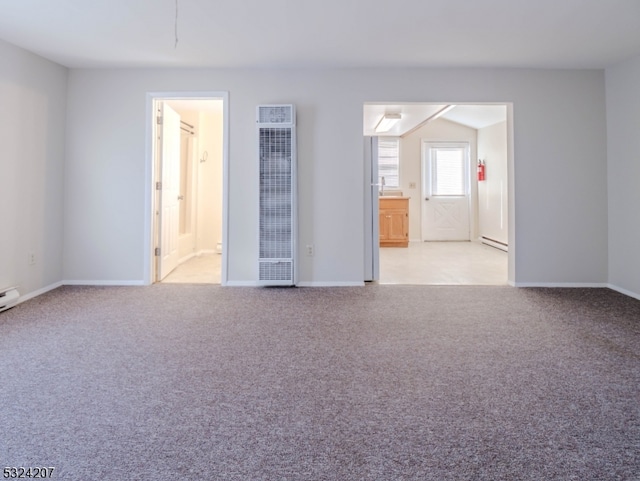 unfurnished room featuring light colored carpet and a baseboard radiator