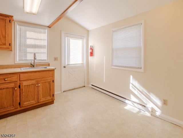 kitchen featuring lofted ceiling, sink, and a baseboard heating unit