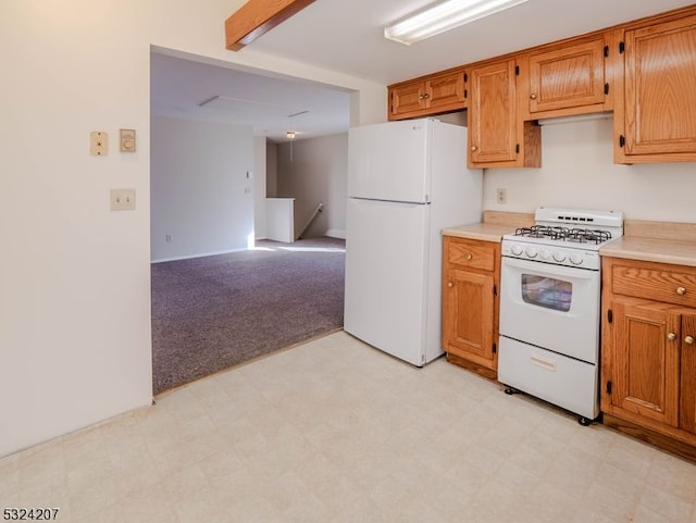 kitchen with light carpet and white appliances