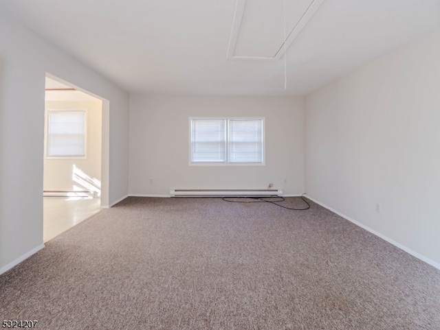 carpeted empty room with a healthy amount of sunlight and a baseboard heating unit