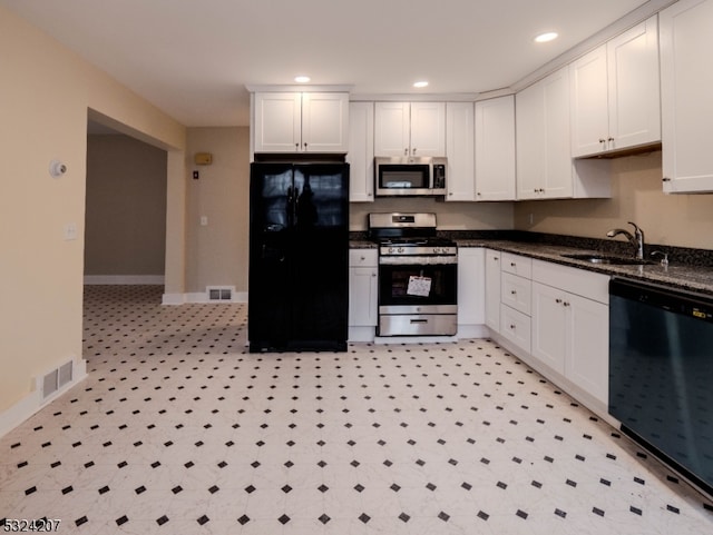 kitchen with white cabinets, sink, dark stone countertops, and black appliances