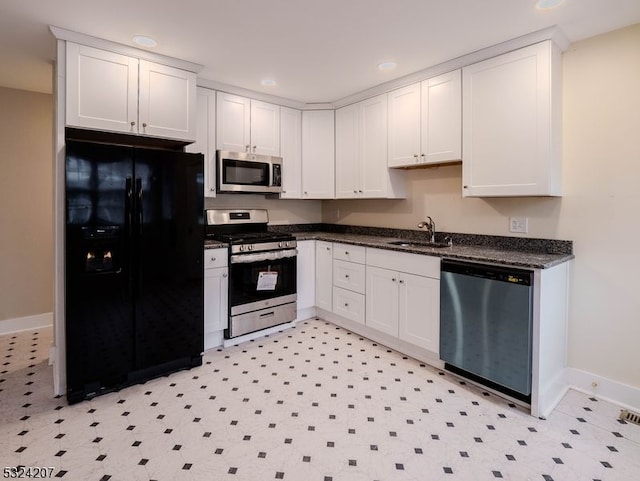 kitchen with sink, white cabinets, and stainless steel appliances