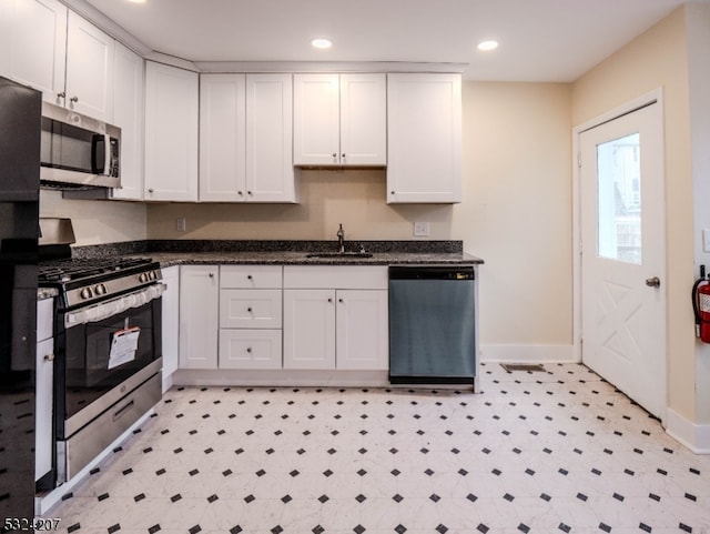 kitchen with white cabinetry, sink, and stainless steel appliances