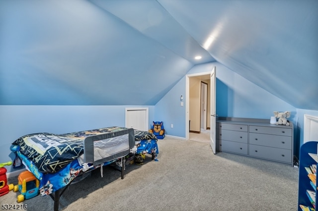 carpeted bedroom featuring vaulted ceiling