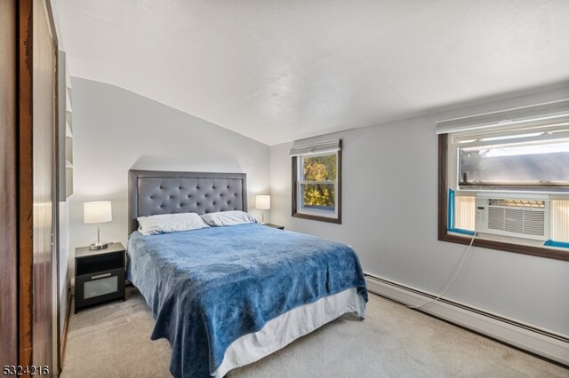 carpeted bedroom with cooling unit, vaulted ceiling, and a baseboard heating unit