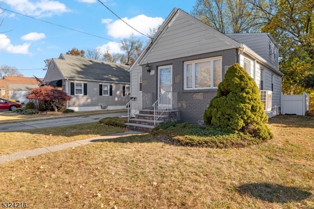 bungalow-style home featuring a front yard