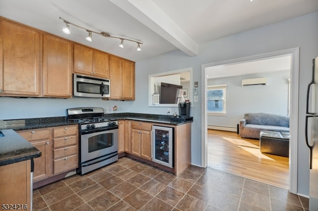 kitchen with a baseboard radiator, a wall unit AC, dark hardwood / wood-style floors, appliances with stainless steel finishes, and wine cooler