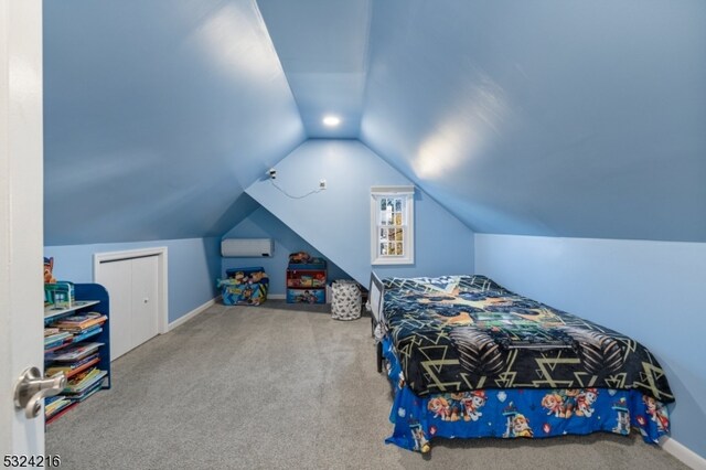 carpeted bedroom featuring a closet and vaulted ceiling